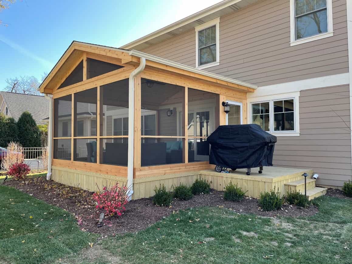 Screened porch with a small wood deck by Archadeck of Chicagoland-Naperville.